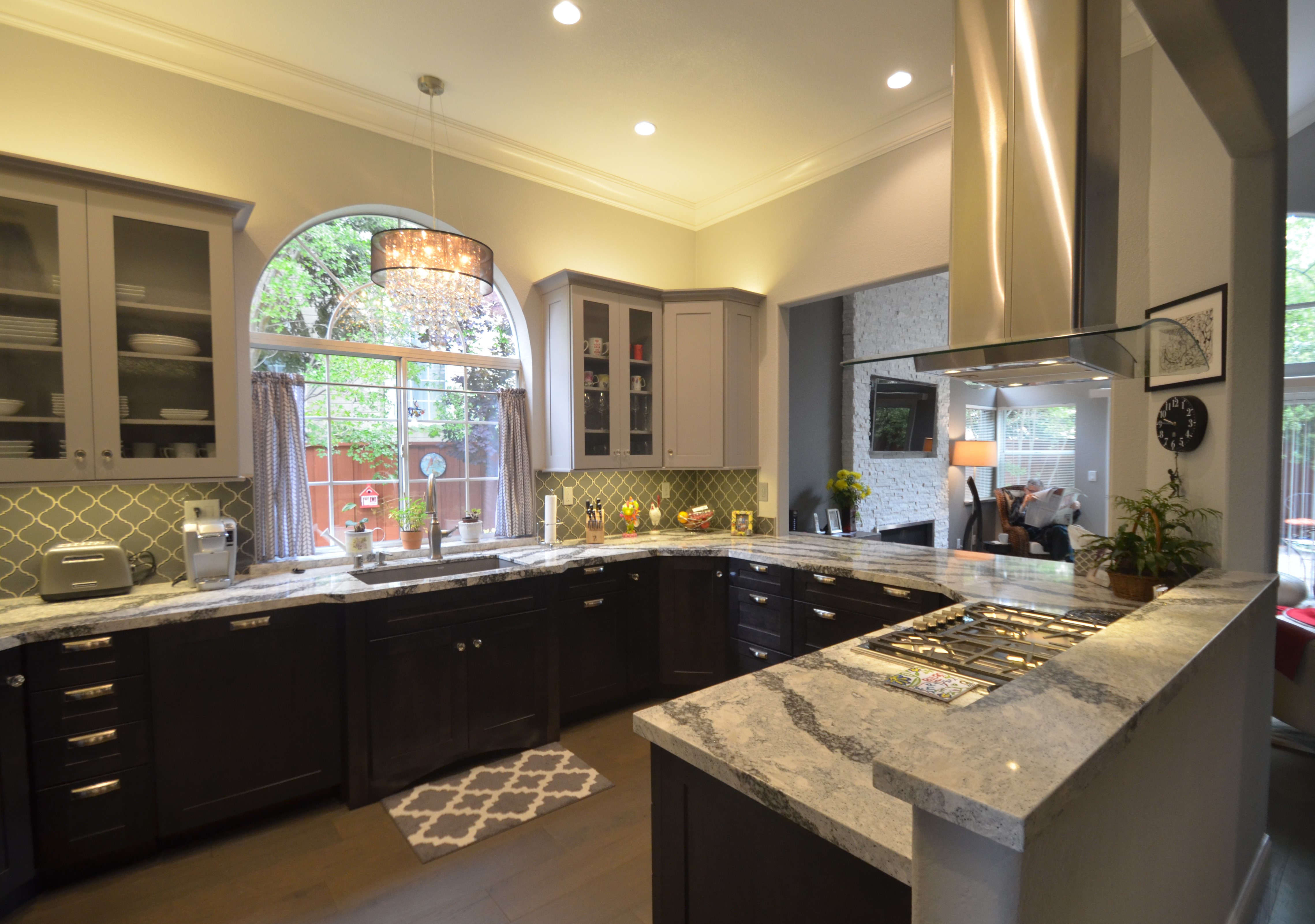 U shaped kitchen layout with large chandelier 