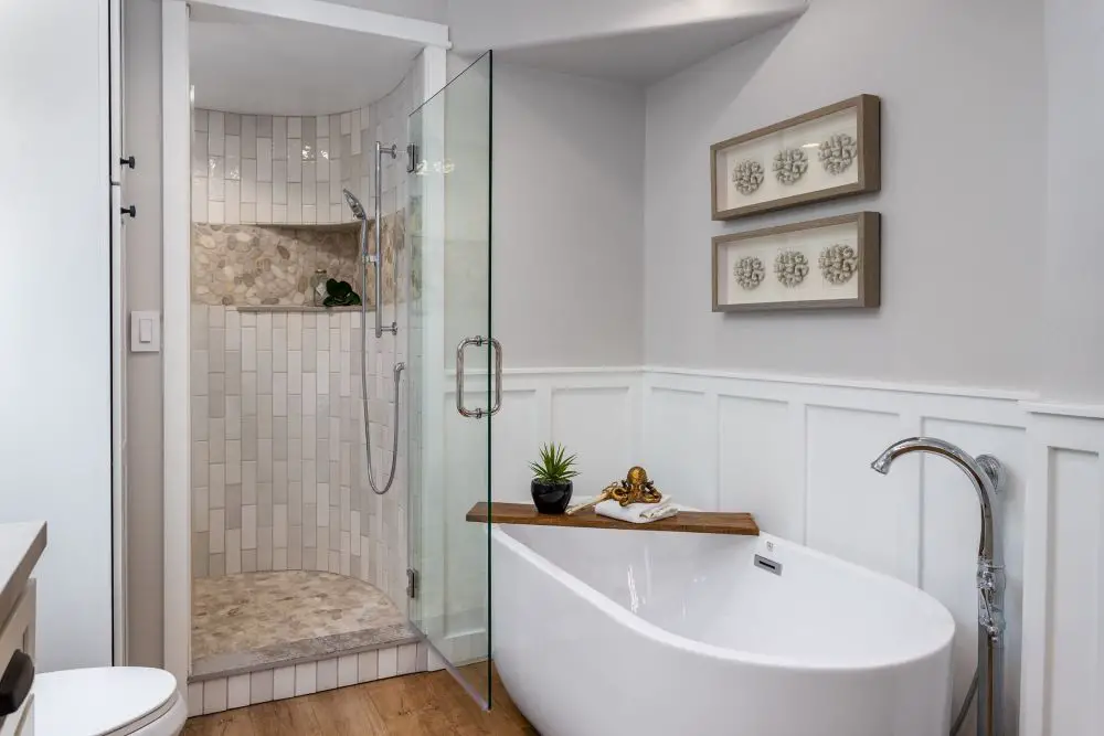 Bathroom remodel with freestanding tub and walk-in glass shower with neutral tile