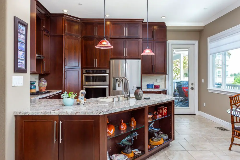 Warm contemporary kitchen featuring rich cherry cabinets, granite countertops, and pendant lighting, designed and built by Toupin Construction in the East Bay.