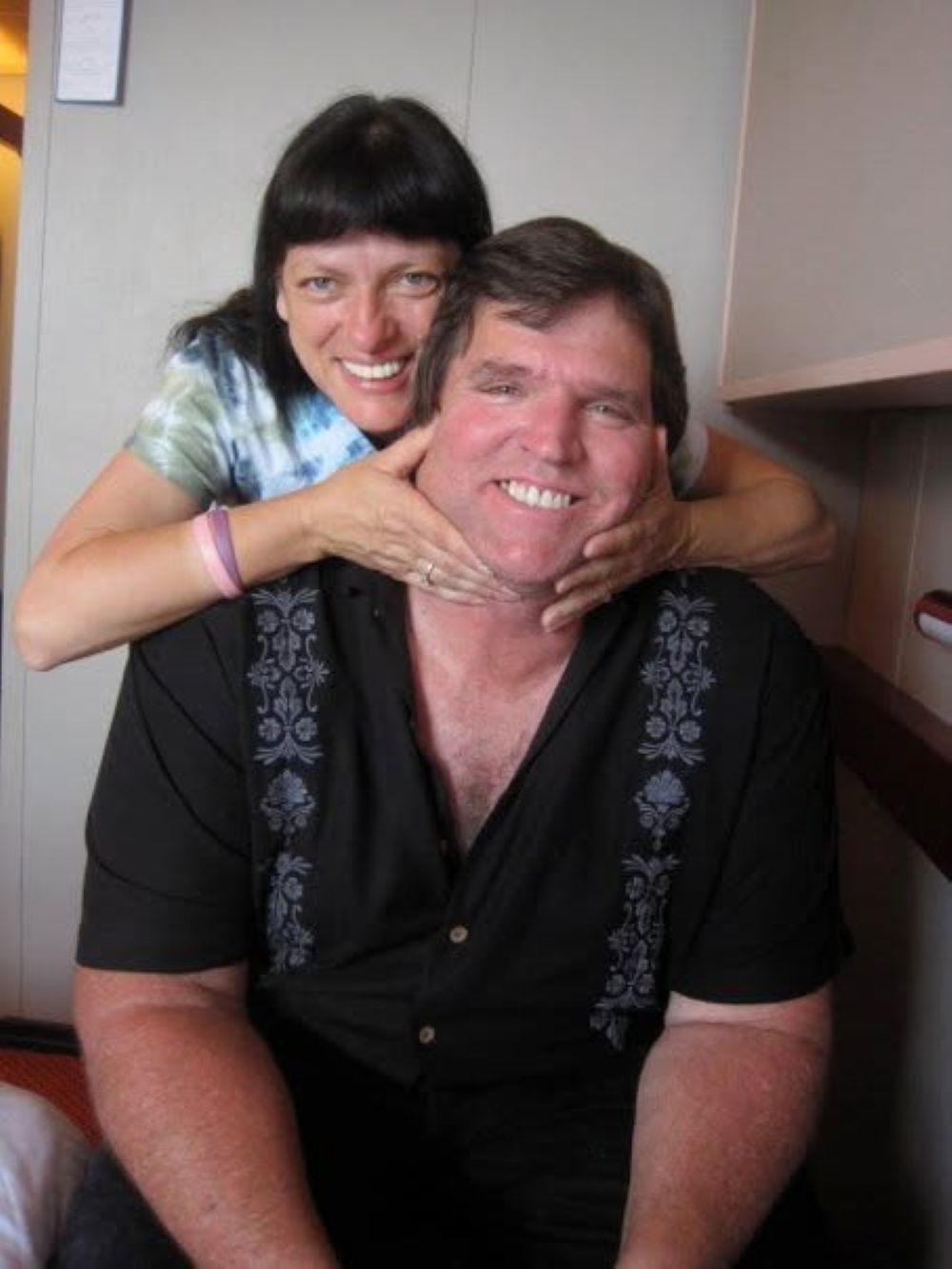 Happy couple smiling together in a candid family portrait.