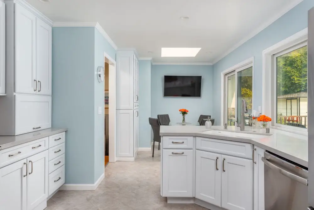 Soft blue painted walls with white cabinets and trim in a remodeled Lafayette kitchen.