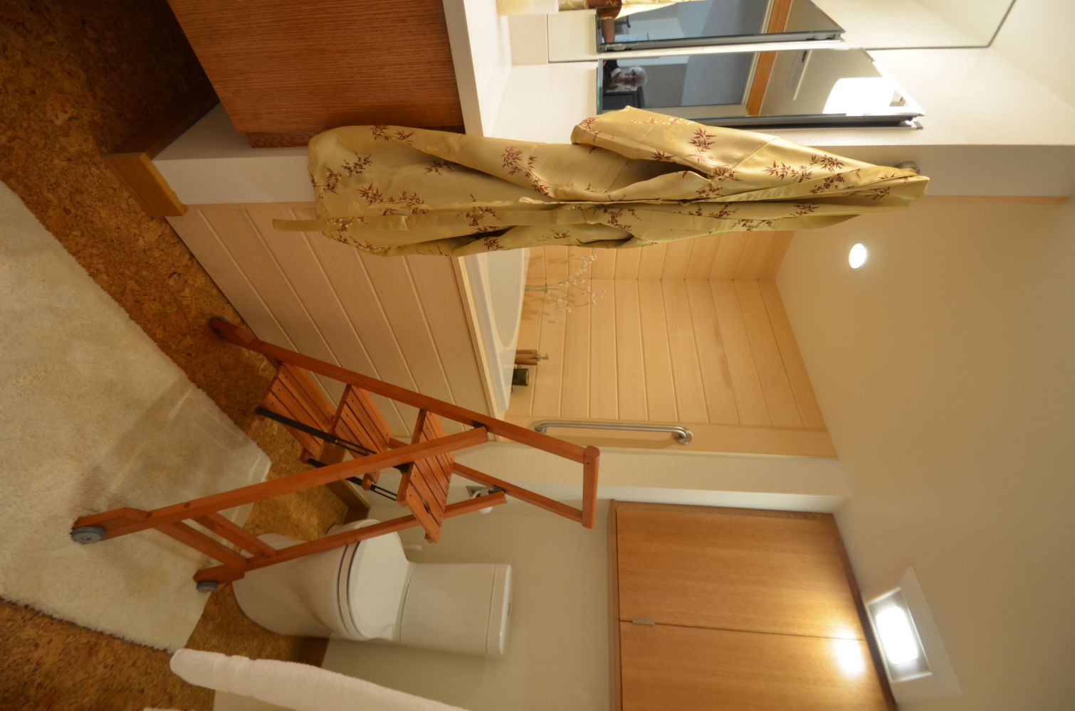 Small bathroom with bathtub, step ladder, and ceiling exhaust vent located near corner