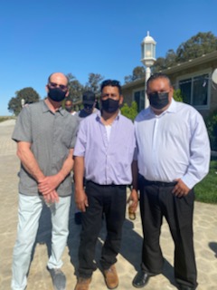 three man at a funeral