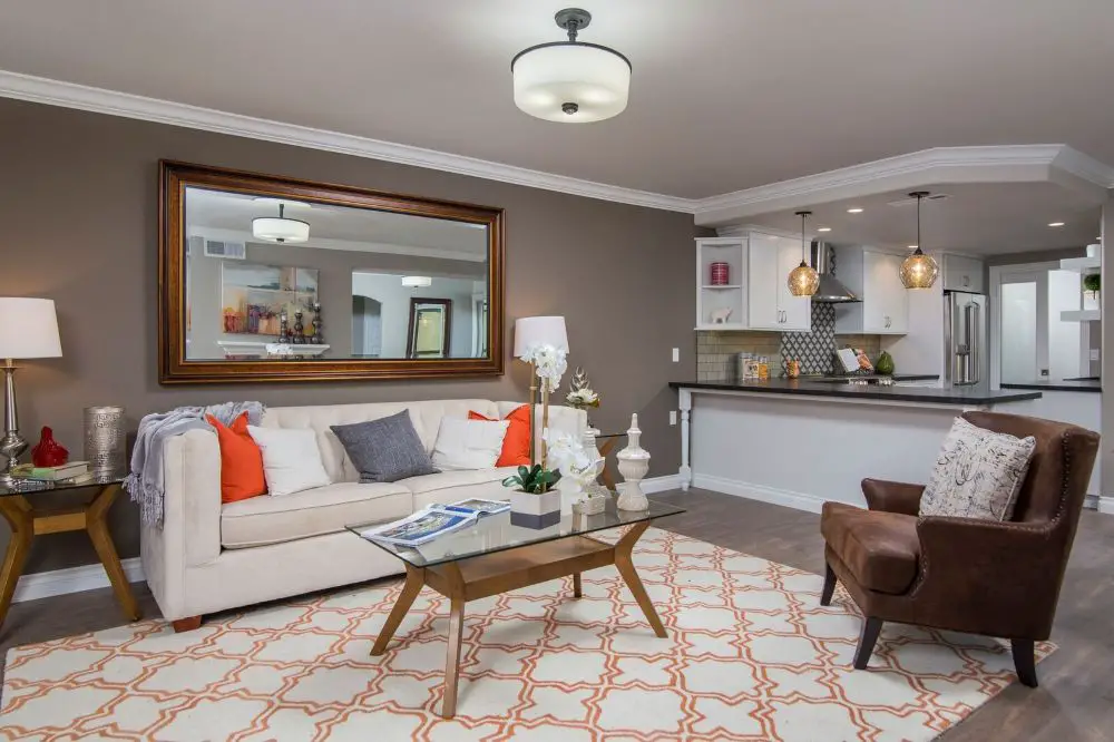 Modern open concept condo living room and kitchen with partial wall openings designed for HOA and shared-wall constraints