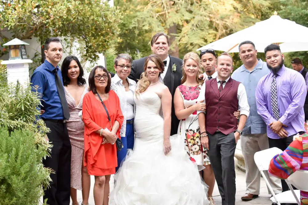 Tim Toupin standing with family, friends, and employees at a wedding celebration.