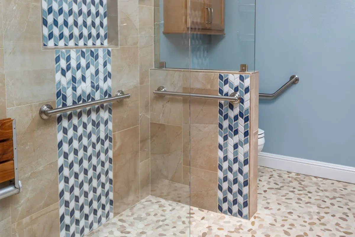 Accessible walk-in shower with grab bars and mosaic accent tile