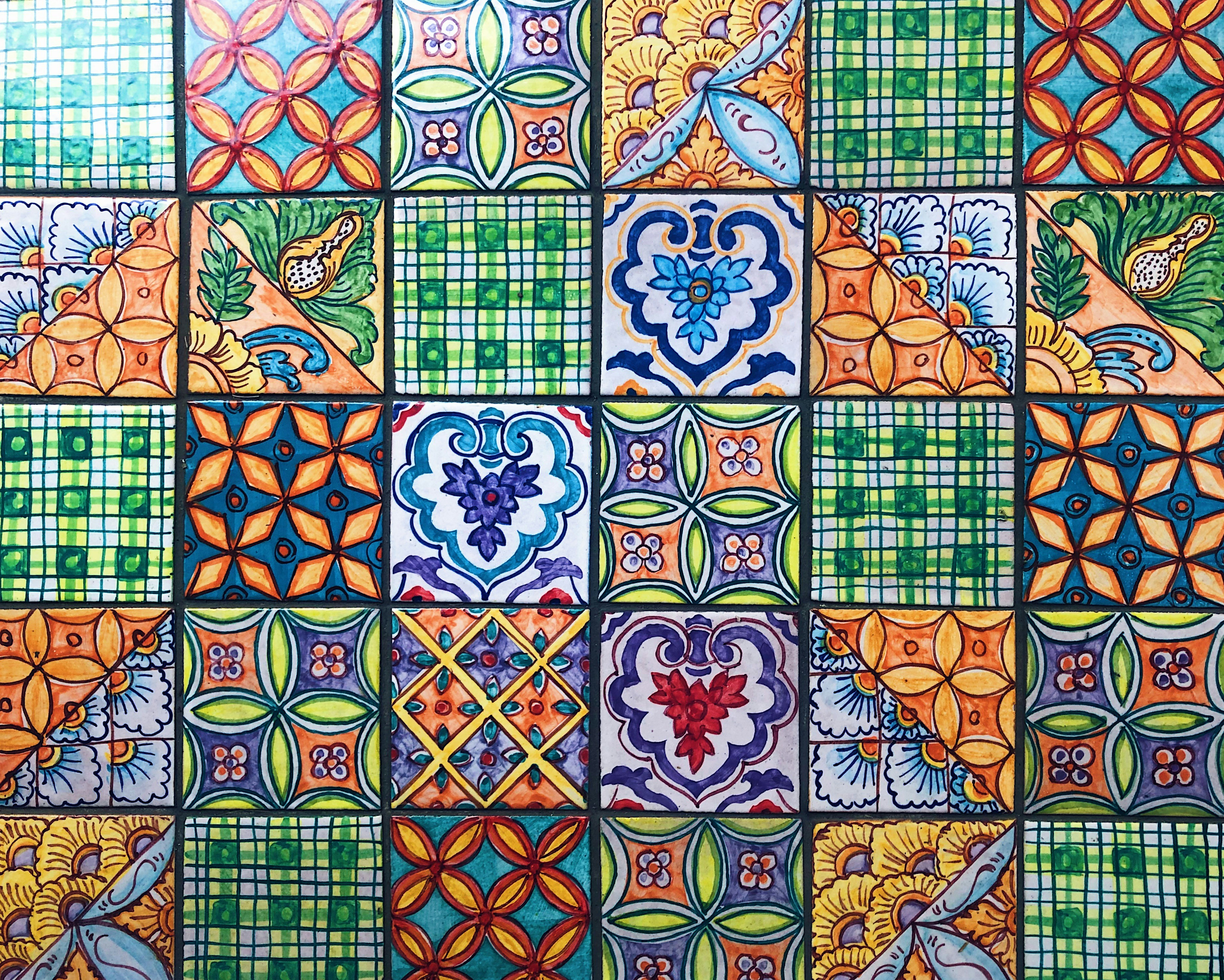 Colorful Moroccan mosaic tile backsplash with turquoise and floral patterned ceramic tiles.