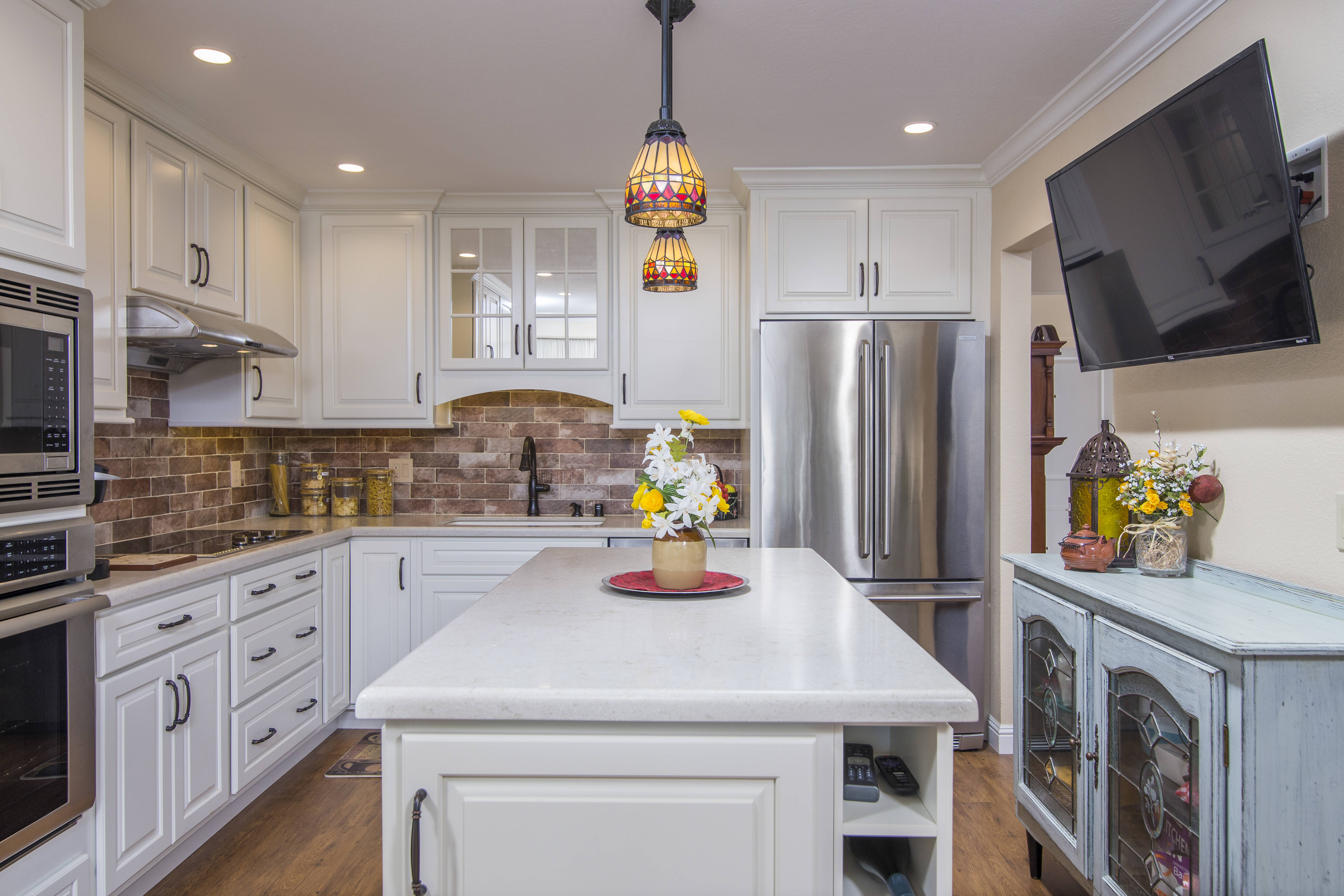 Brick style tile backsplash in neutral tones with white cabinets in East Bay kitchen