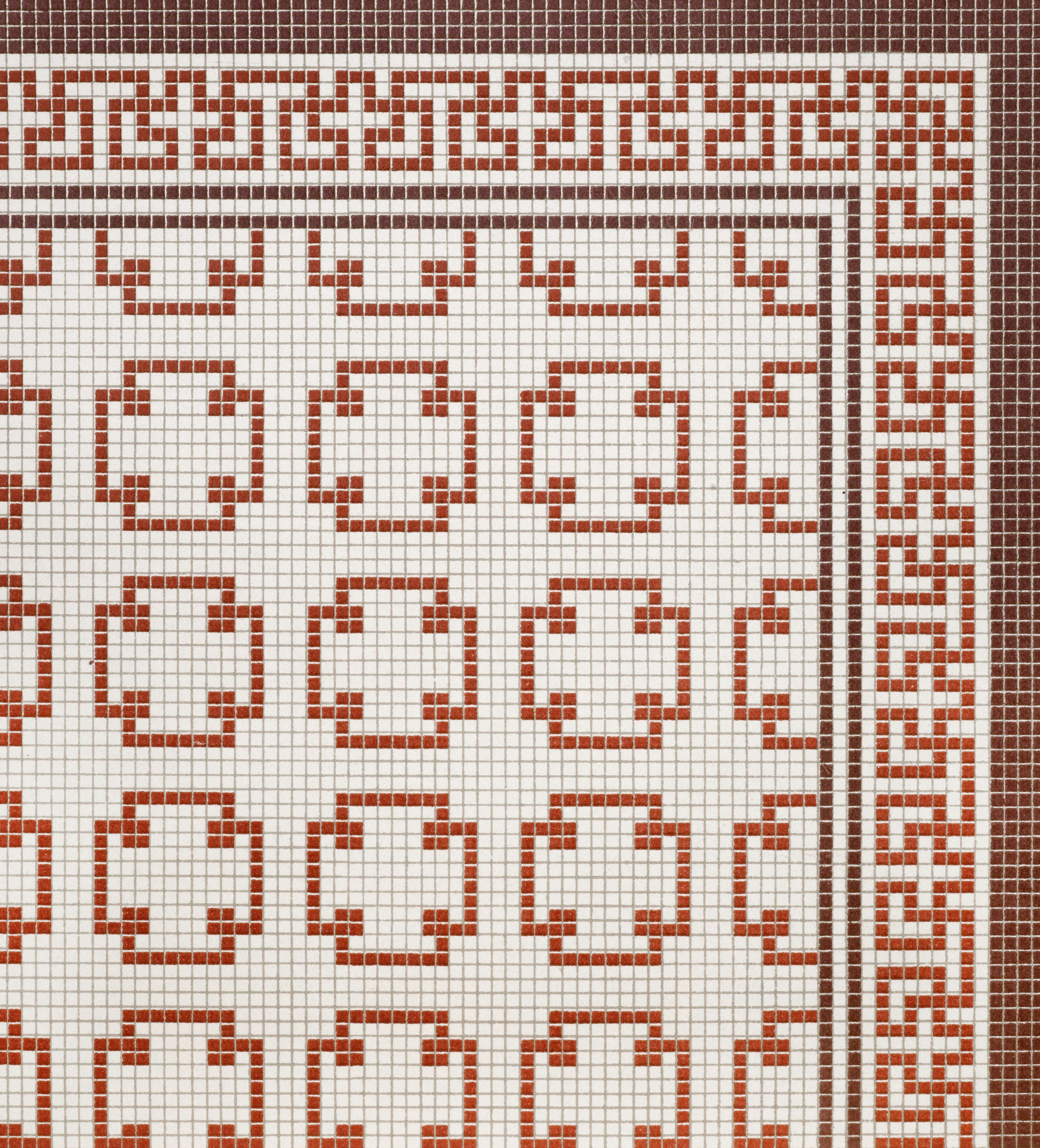 Red and white Greek key mosaic tile pattern with small square ceramic tiles.
