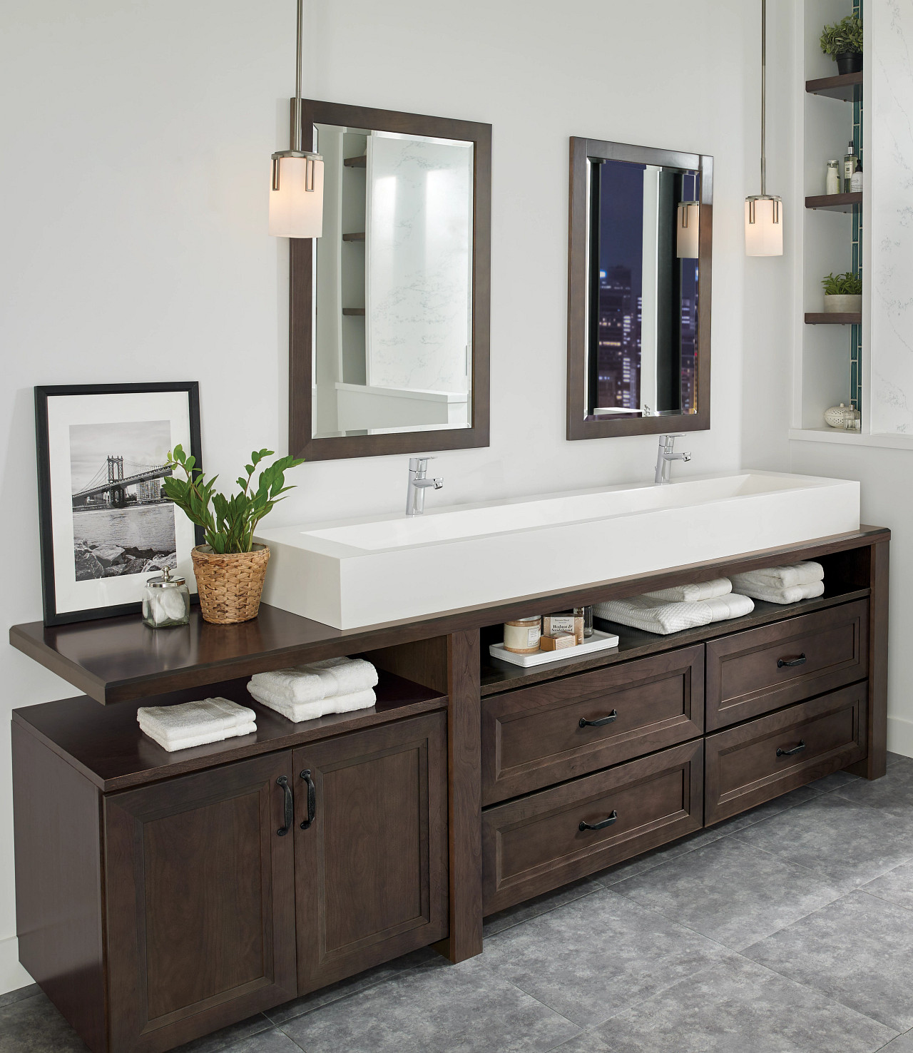 Bathroom with dark wood double vanity, white countertop, modern mirrors, and neutral walls.