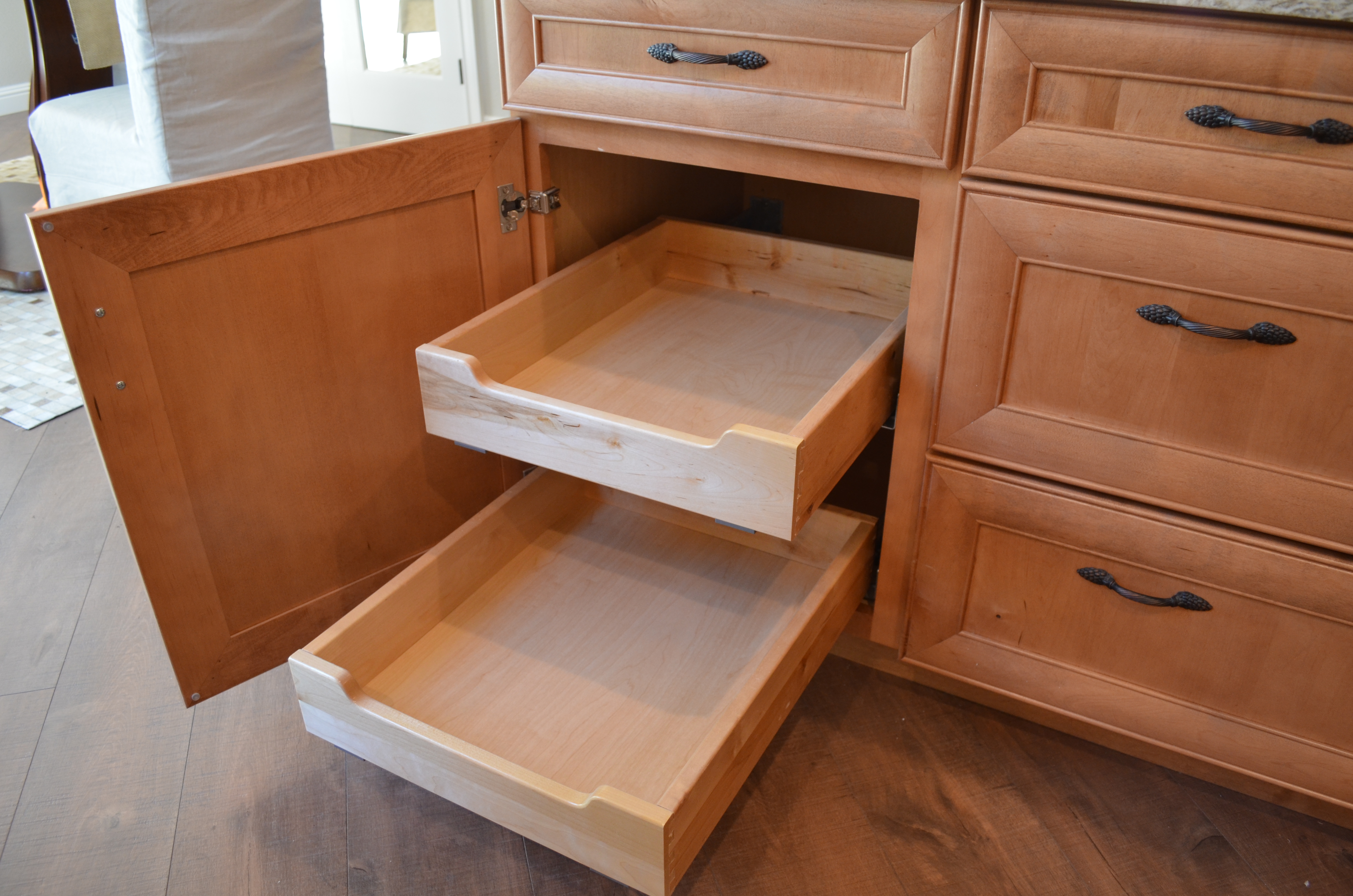 Pull out pantry drawers in kitchen cabinet for organized and accessible storage.