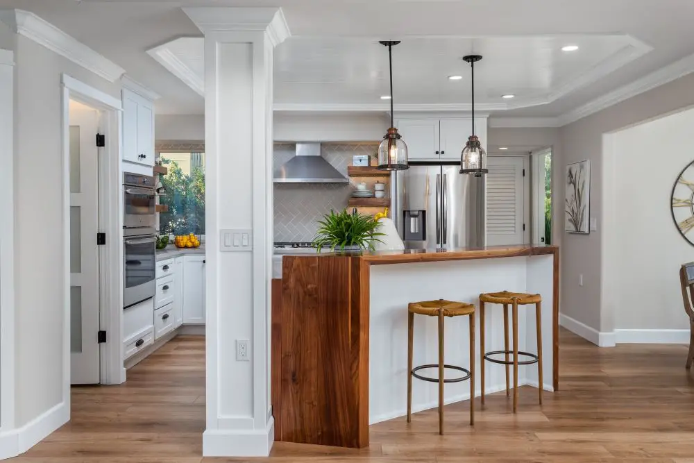 Open-concept kitchen remodel with white cabinets, wood accent island, quartz countertops, and pendant lighting in Walnut Creek