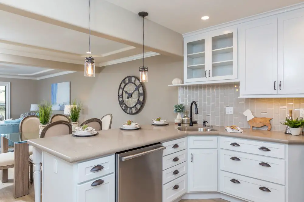 Open concept kitchen with island connected to dining and living room in modern home.