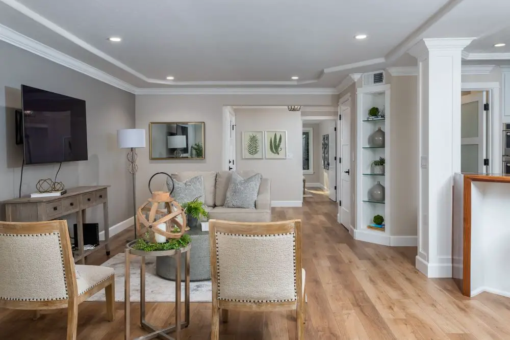 Open-concept living room with neutral design, wood flooring, and recessed lighting