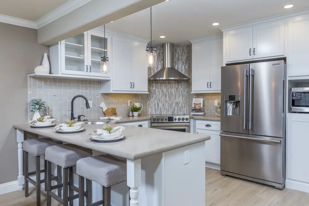 Kitchen with white cabinets and mixed lighting showing how paint colors change under different light sources