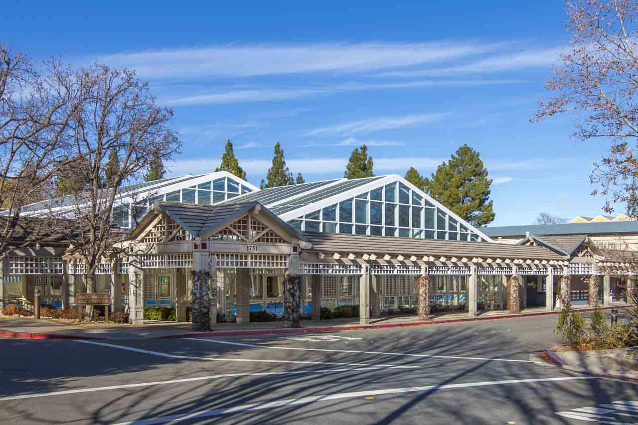 Rossmoor community building with glass roof and covered walkway in Walnut Creek
