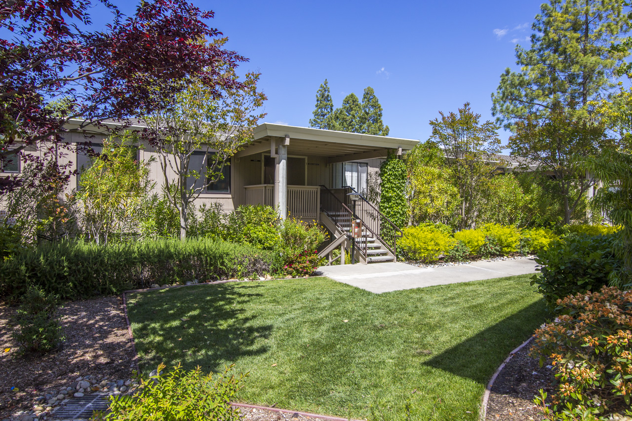 Residential homes in Rossmoor community with landscaped gardens and walking paths.