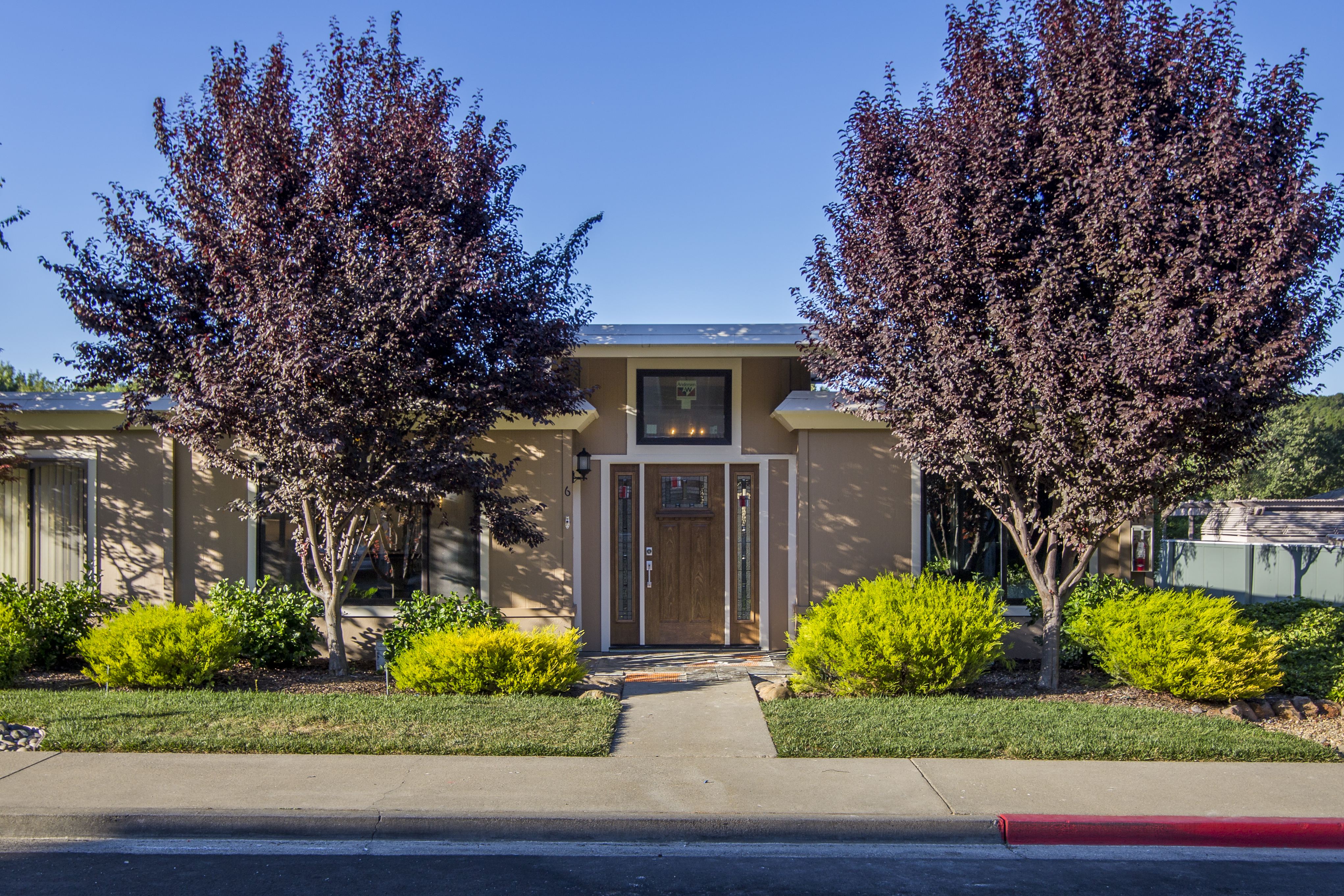 Rossmoor home entrance with landscaped walkway and mature trees in Walnut Creek