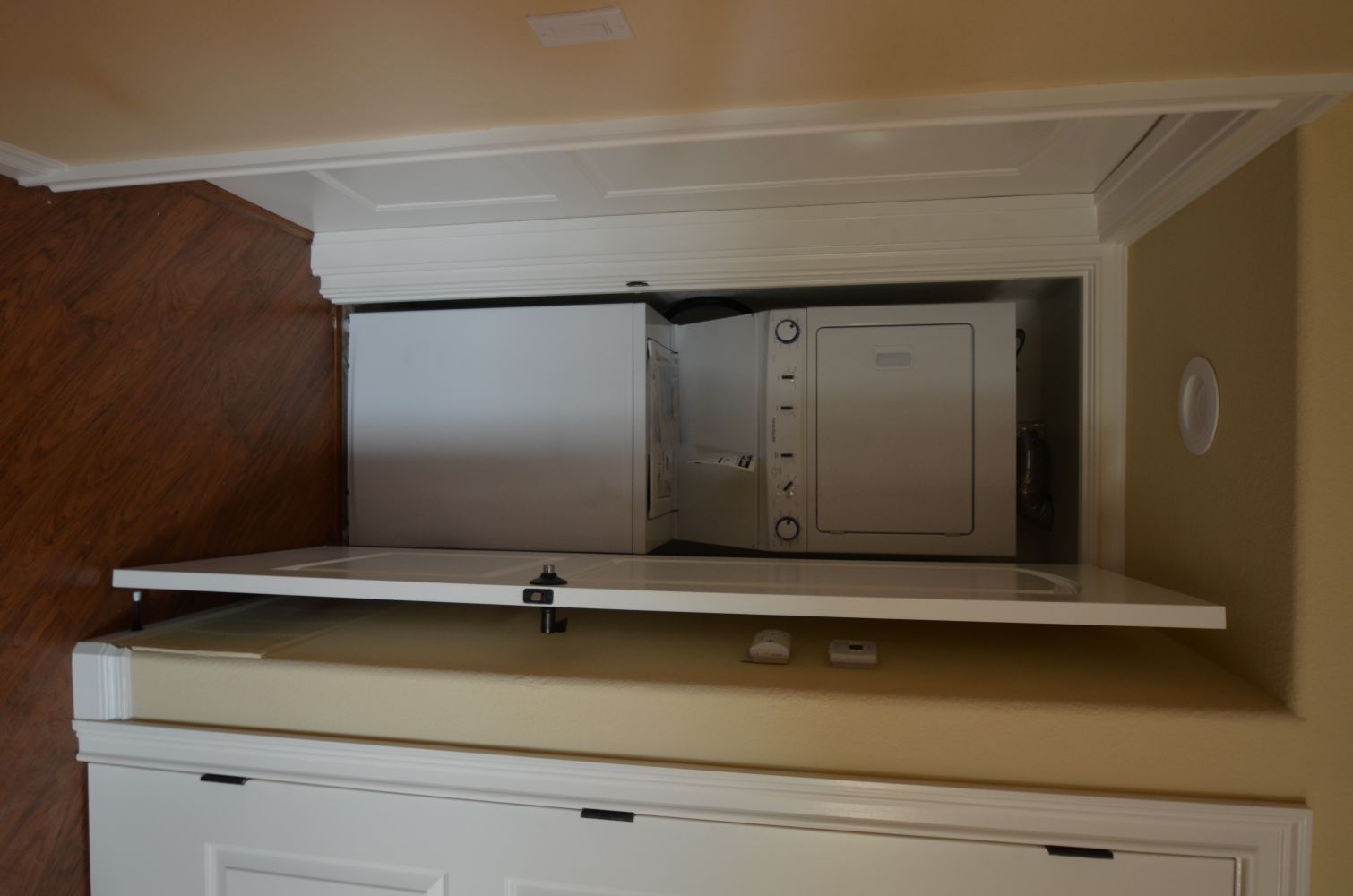 Stacked washer and dryer in small laundry closet Rossmoor Walnut Creek CA tight space limited storage design