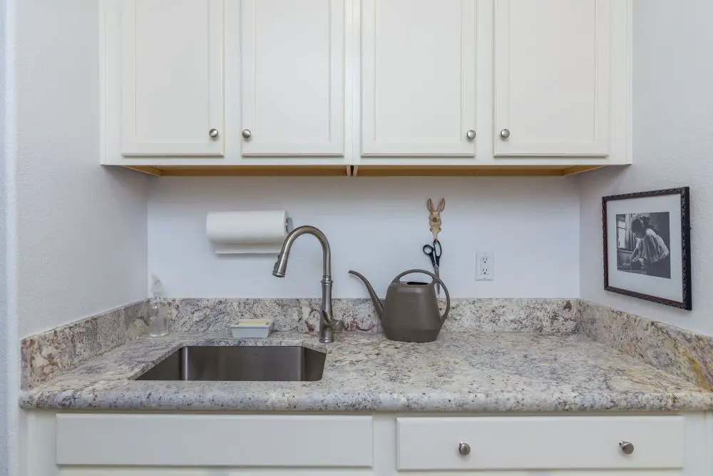 Laundry room sink and folding counter Rossmoor Walnut Creek CA with upper cabinets and utility workspace