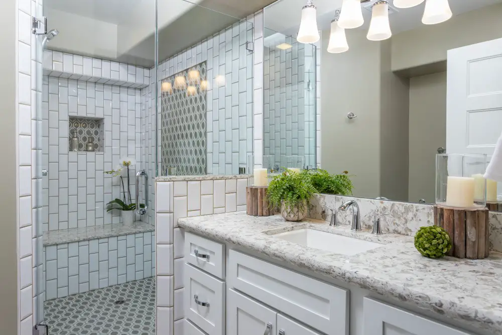 Bathroom with subway tile shower, built-in bench, and recessed niche.