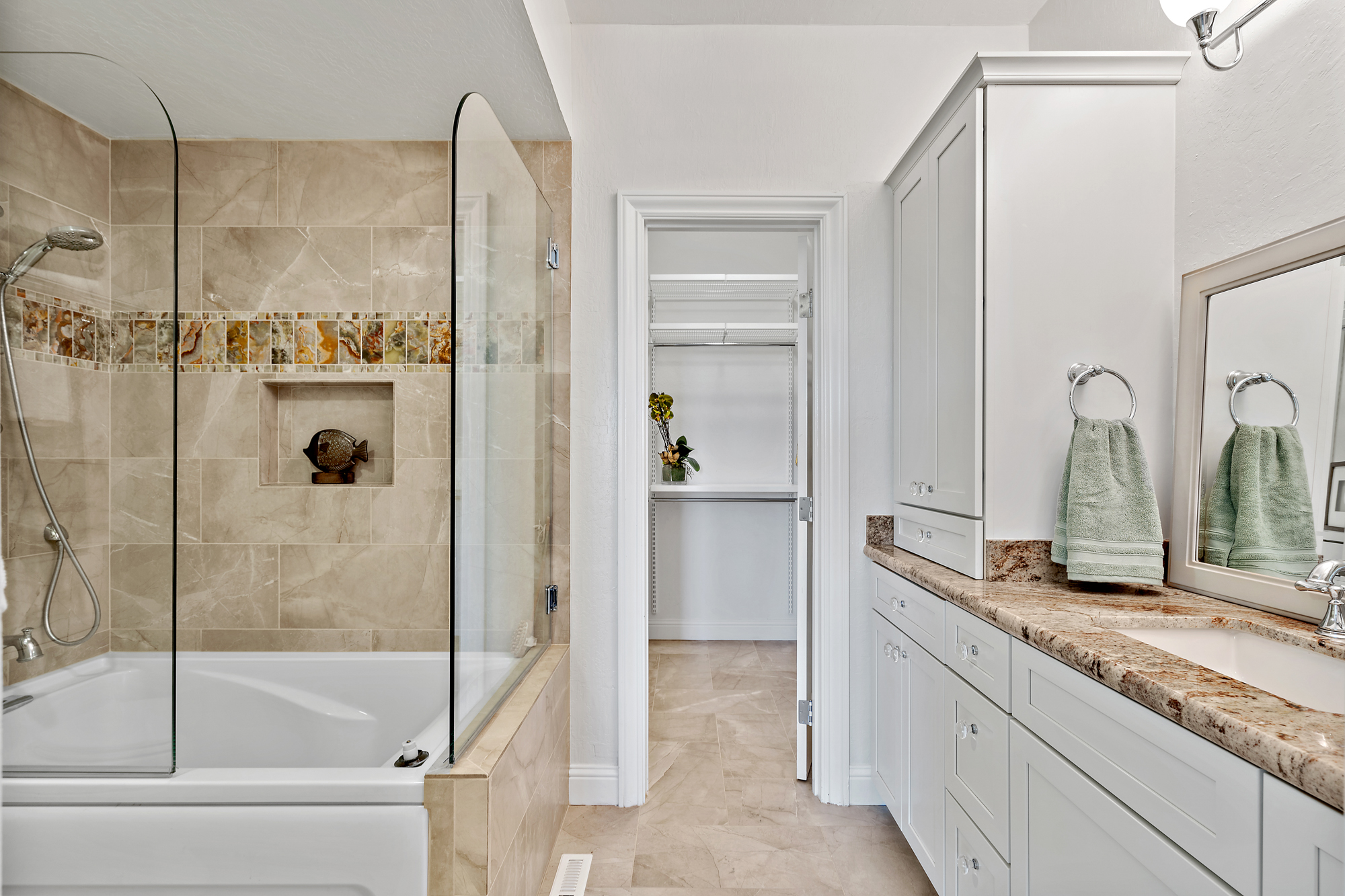 Bright neutral bathroom with tub shower and clean finishes appealing to home buyers