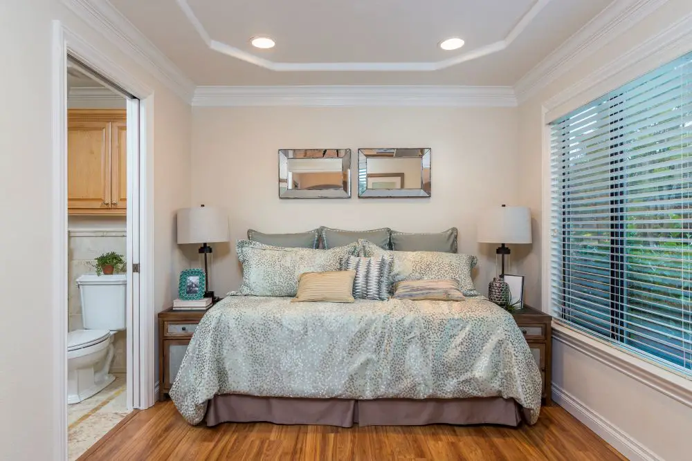 Bedroom with dimmable recessed lighting and lamps creating a soft ambient glow