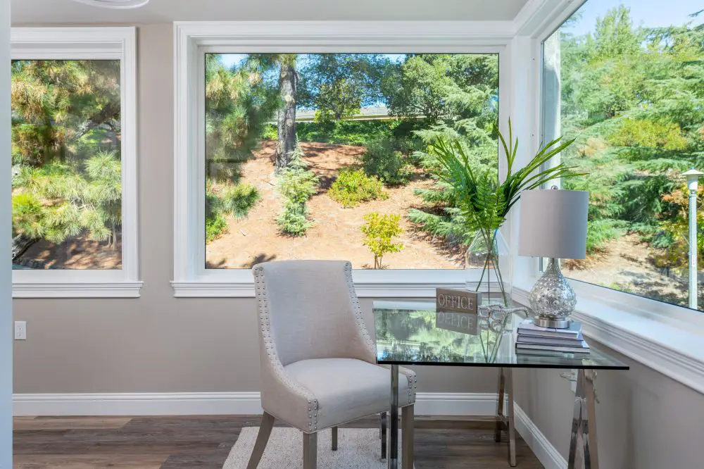 Corner windows with white trim in Walnut Creek home office nook bringing in natural light and soft contrast