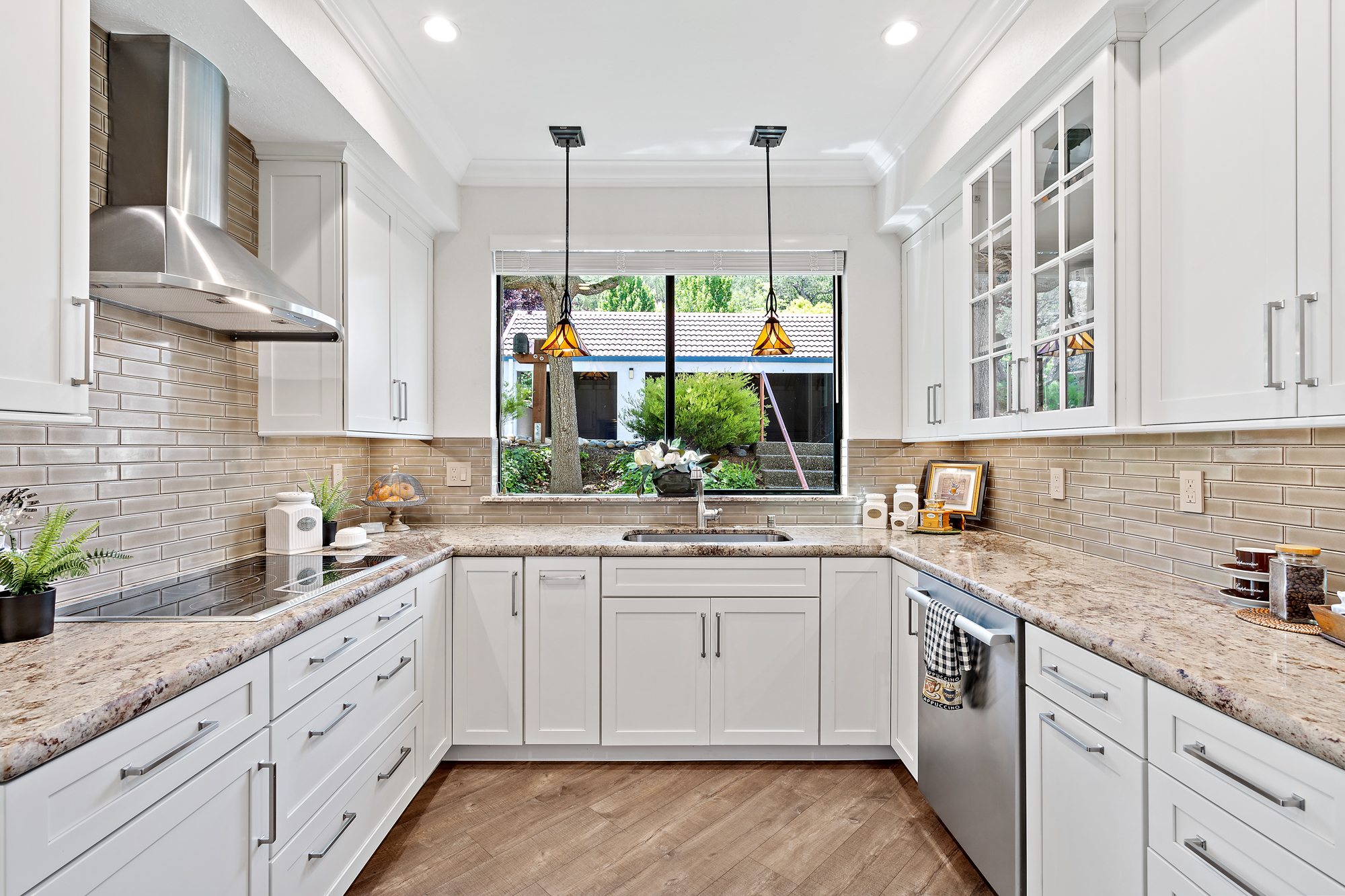 Bright kitchen with natural light white cabinets and warm finishes creating an inviting atmosphere
