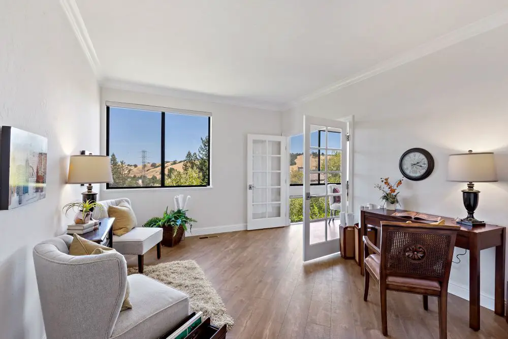 Bright living room with French doors, wood floors, and natural light