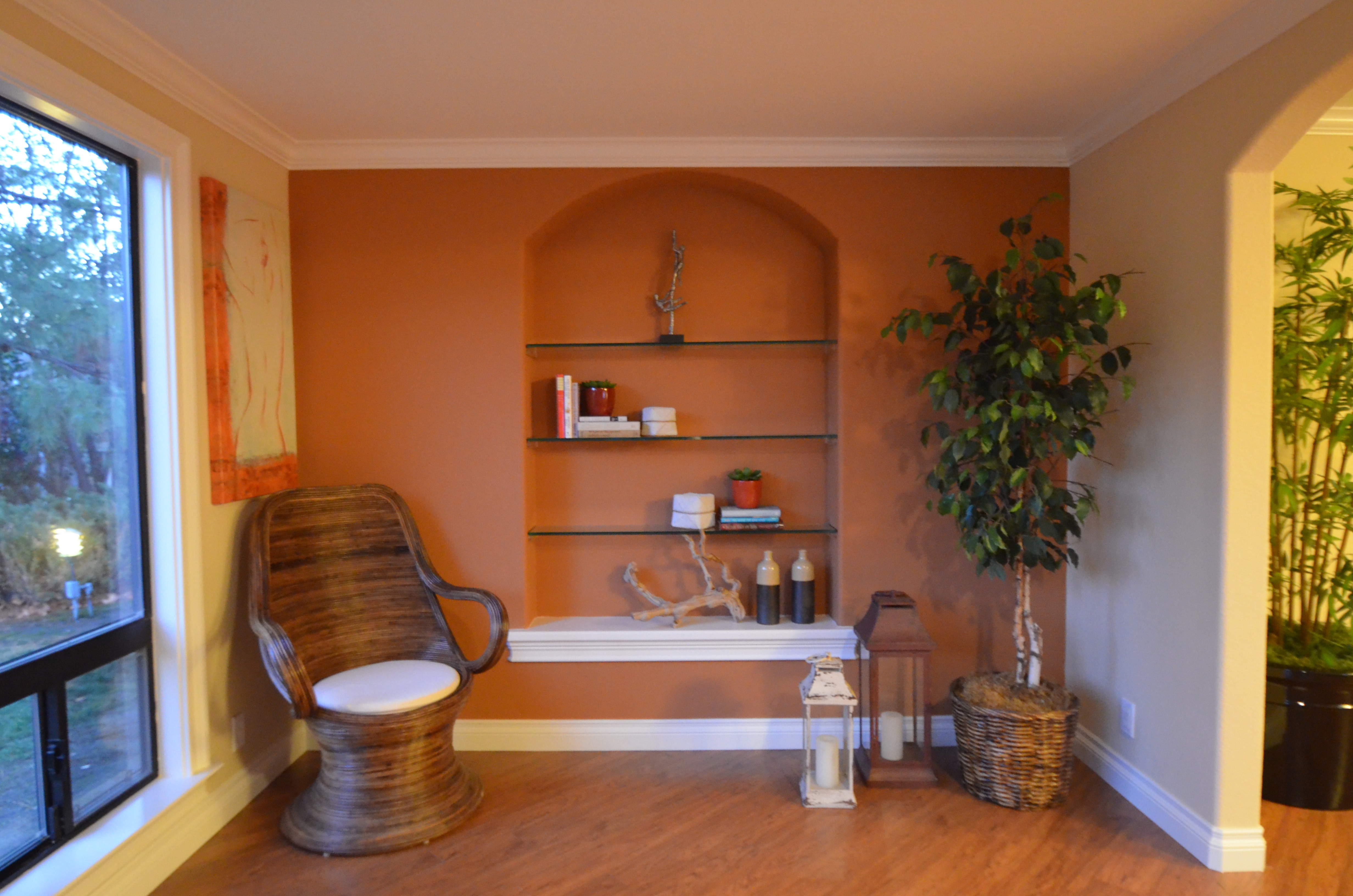 Terracotta accent wall with arched niche and floating shelves in Walnut Creek home