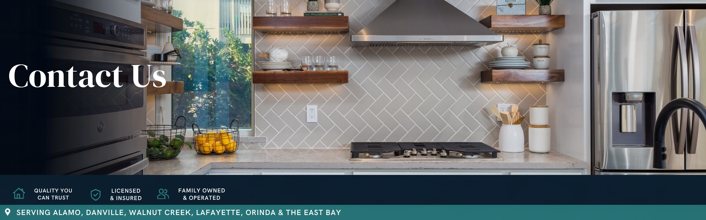 Modern kitchen remodel featuring white shaker cabinets, floating wood shelves, herringbone tile backsplash, stainless steel range hood, and quartz countertops by Toupin Construction.