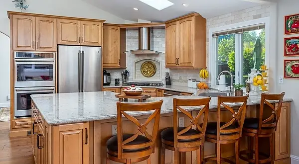 Orinda kitchen remodel featuring a large island with seating, wood cabinetry and stainless appliances. Eastwood Kitchen & Bathroom Remodel | Orinda
