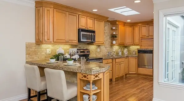 Traditional wood kitchen with granite counters and island seating in a Golden Rain remodel in Rossmoor, Walnut Creek. 1301 Golden Rain Remodel | Rossmoor Renovation by Toupin Construction